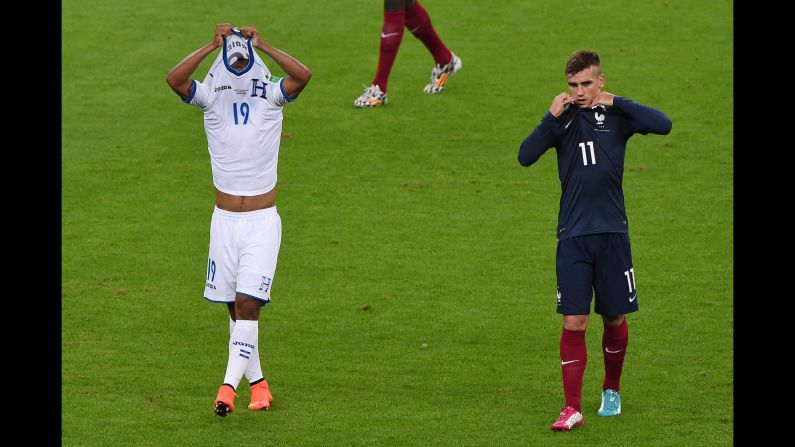 Honduras midfielder Luis Garrido, left, and France forward Antoine Griezmann leave the field at the end of the World Cup Group E match at Estadio Beira-Rio on June 15 in Porto Alegre.  France defeated Honduras 3-0. 