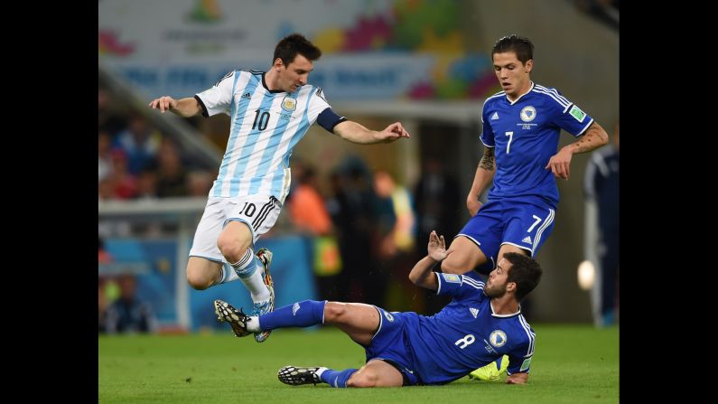Argentina forward and captain Lionel Messi fights for the ball with Bosnia-Herzegovina defender Muhamed Besic and midfielder Miralem Pjanic.