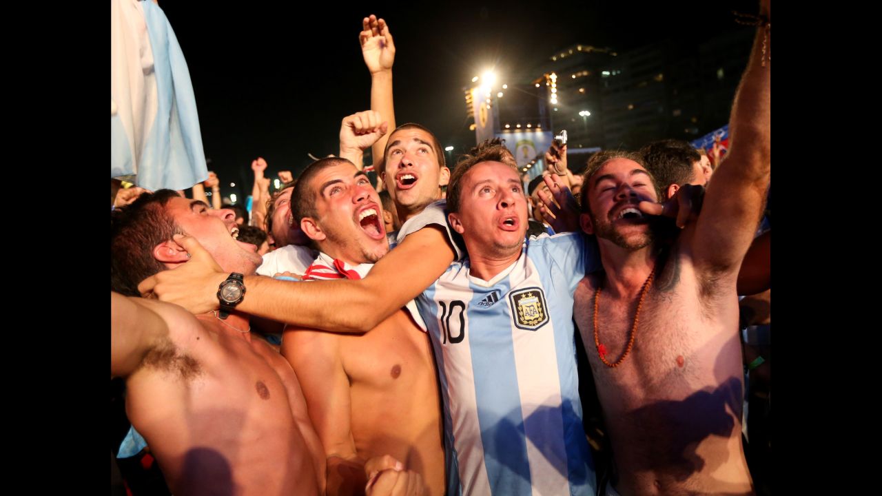 Argentine fans react to their team's first goal as they watch on a giant screen on Copacabana beach in Rio de Janeiro, Brazil.