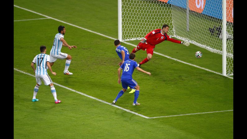 Sead Kolasinac of Bosnia and Herzegovina scores an own goal past goalkeeper Asmir Begovic as Ezequiel Garay and Federico Fernandez of Argentina look on.