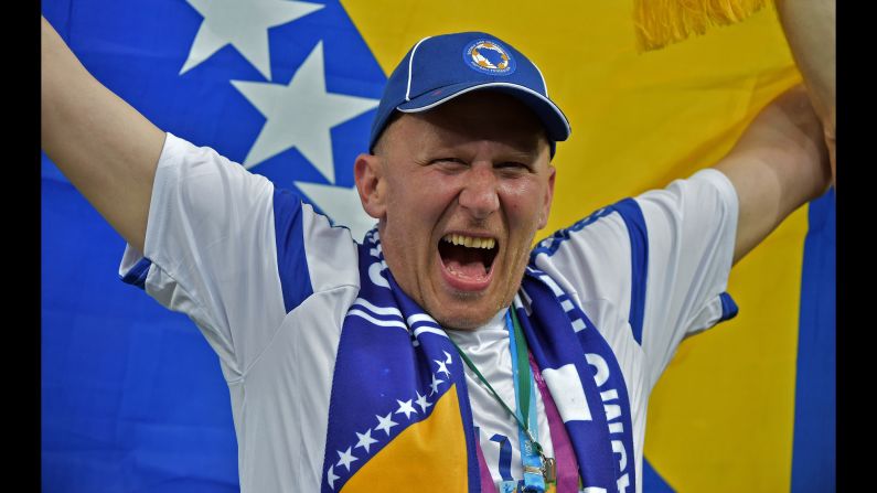 A Bosnian fan cheers for his team ahead of the match. 