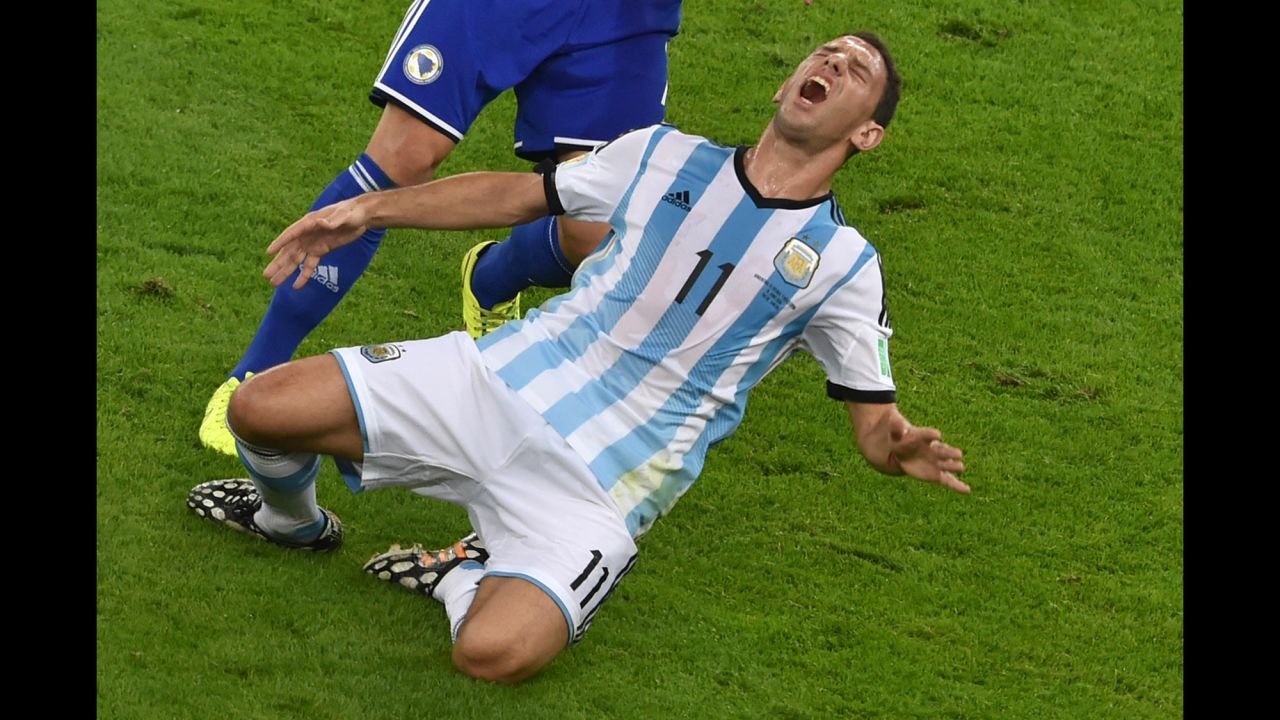 Argentina midfielder Maxi Rodriguez reacts after a tackle by Bosnia-Herzegovina defender Muhamed Besic.