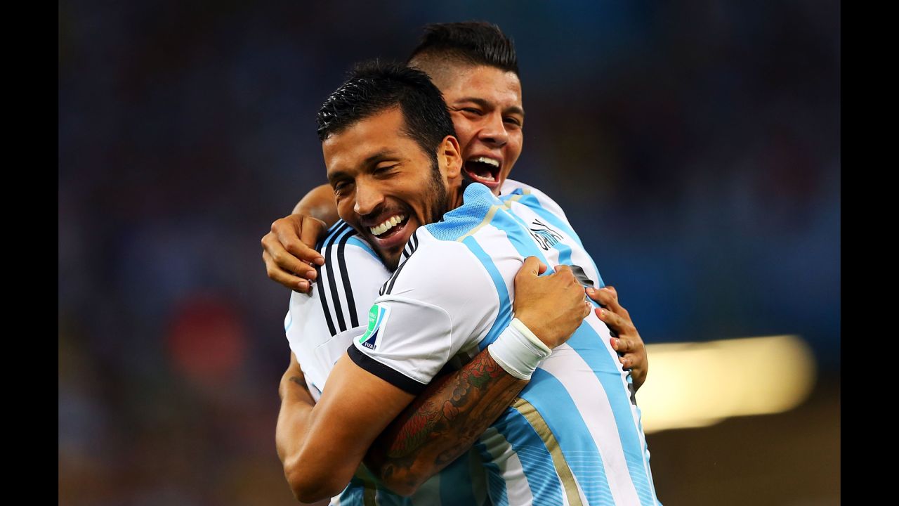 Marcos Rojo and Ezequiel Garay of Argentina celebrate their team's first goal.