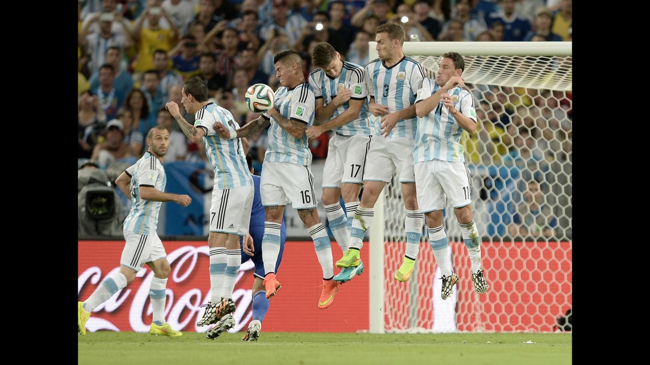 Argentina players leap to block a free-kick by the opposing team. 