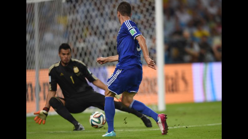 Substitute Vedad Ibisevic shoots past Argentina goalkeeper Sergio Romero to score Bosnia-Herzegovina's historic first World Cup goal Sunday, June 15, at the Maracana Stadium in Rio de Janeiro. But Argentina won the match 2-1.