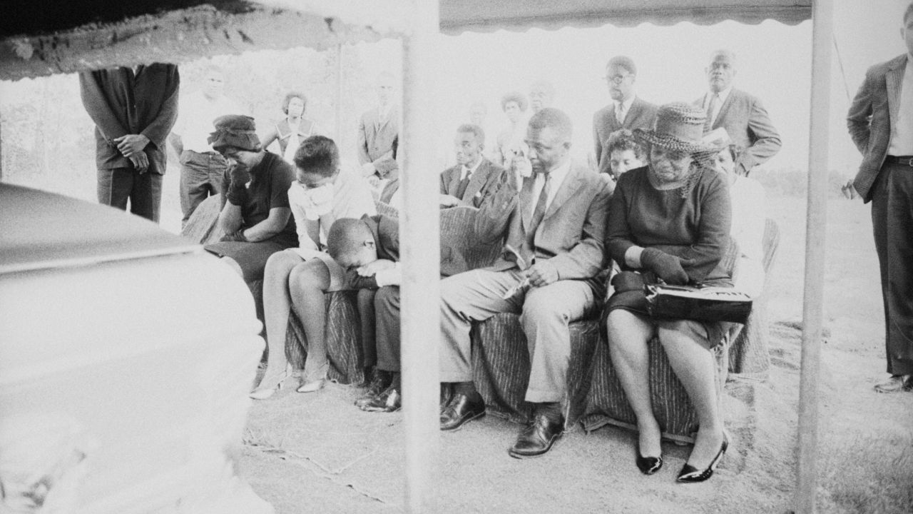 Ben Chaney, slumped over, weeps at the August 7, 1964, funeral of his brother, James Earl Chaney.
