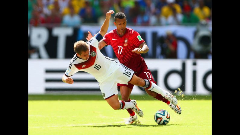 Germany's Philipp Lahm, left, competes for the ball with Portugal's Nani.