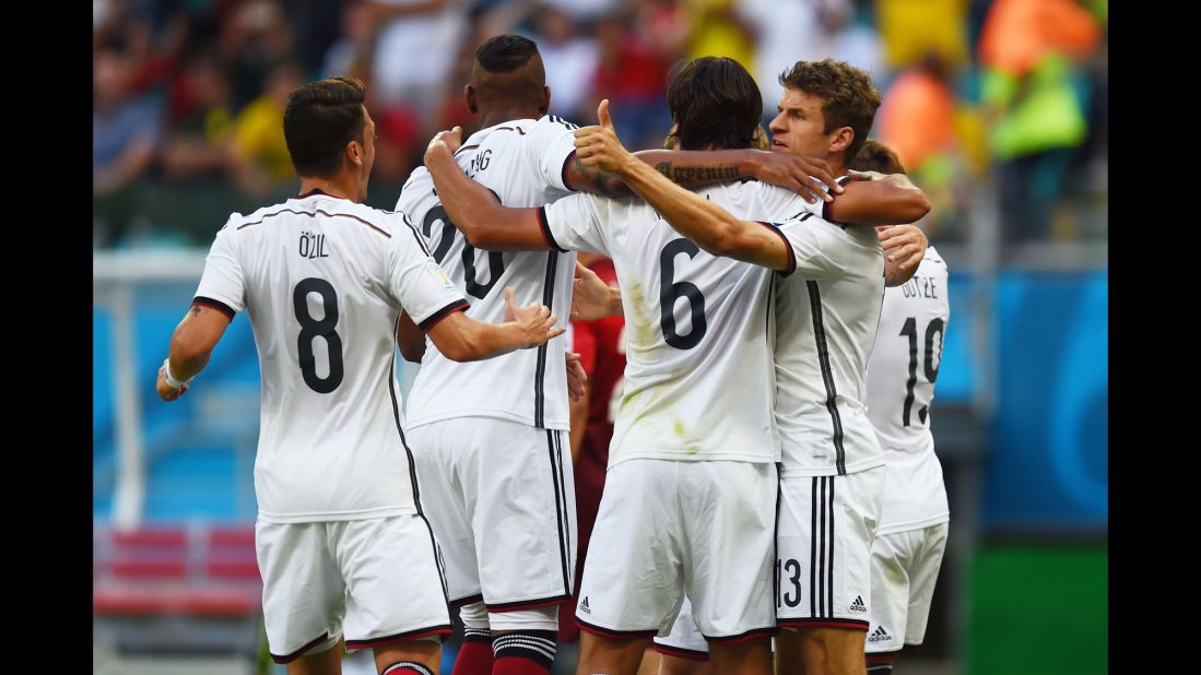 German players celebrate after Mueller, right, converted a penalty kick to open the scoring.