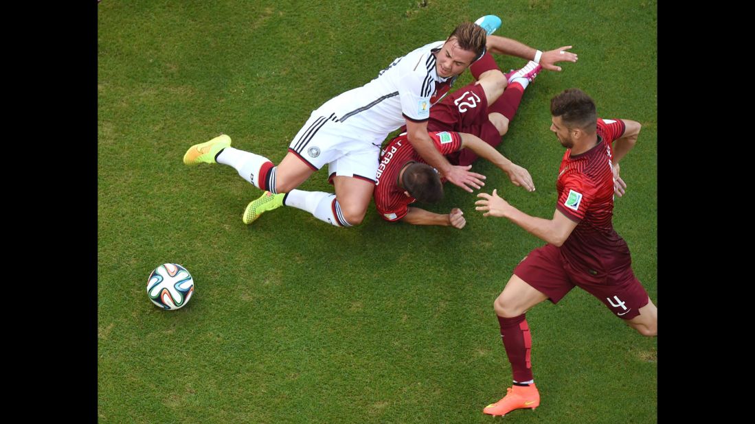 The penalty kick was awarded after Portugal's Joao Pereira, center, fouled Germany's Mario Goetze.