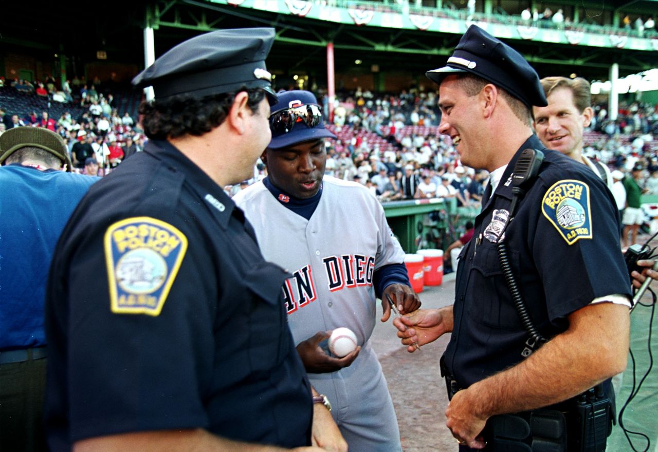 Gwynn signs a baseball for two police officers before the 1999 All-Star Game. Gwynn made the All-Star team in 15 of his 20 seasons.