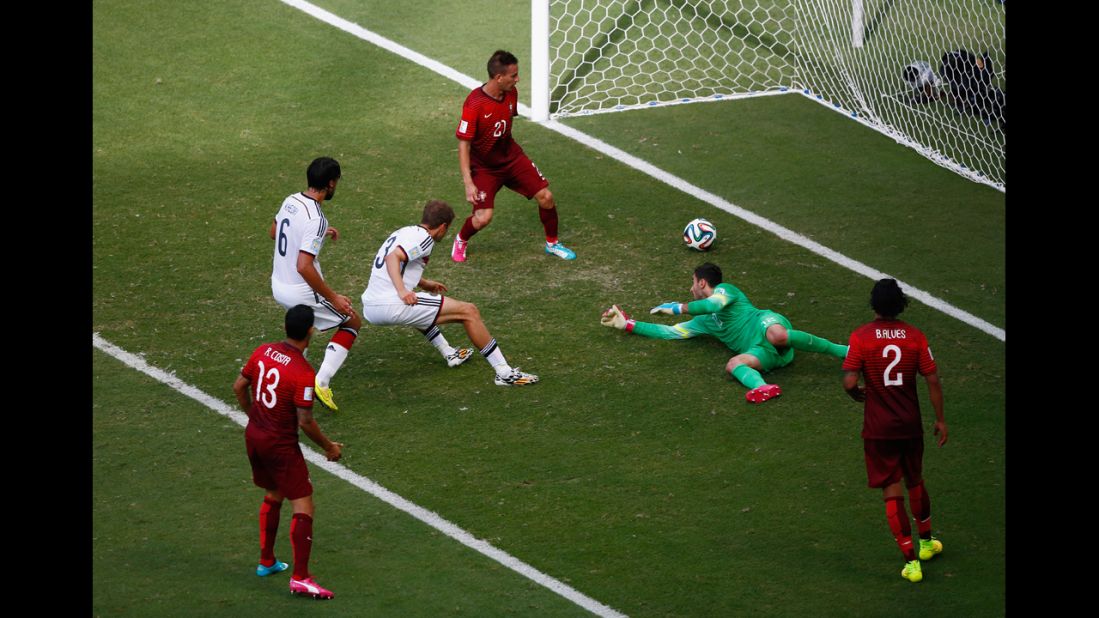 Mueller completes his "hat trick" as he slots the ball past Portuguese goalkeeper Rui Patricio.