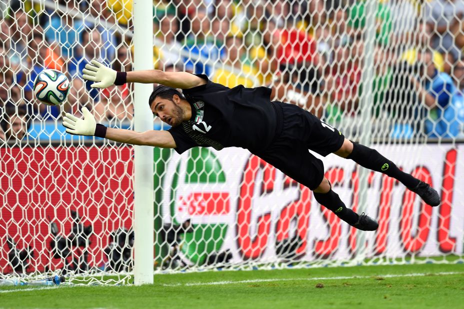 Iranian goalkeeper Alireza Haghighi makes a save against Nigeria. The match ended 0-0 and was the first draw of the tournament.