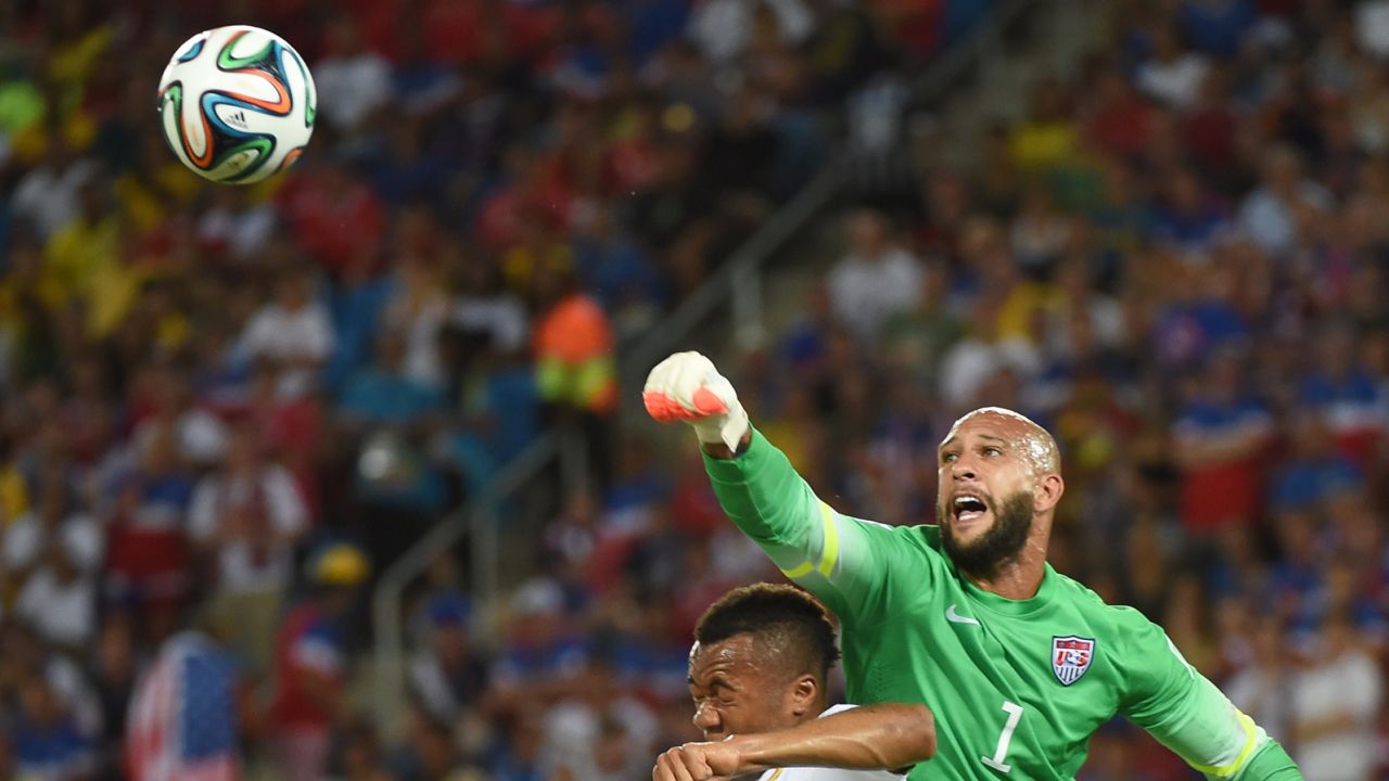 U.S. goalkeeper Tim howard, right, vies with Ghana forward Jordan Ayew.