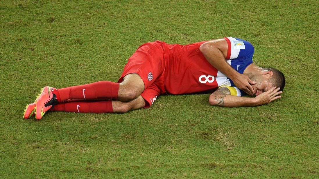 Clint Dempsey of the United States lies on the ground after he was kicked in the nose during a play in the first half. 