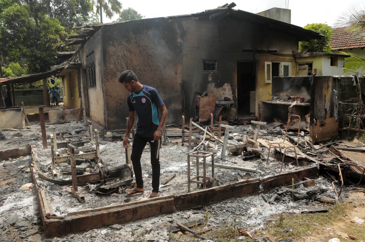 A Sri Lankan Muslim man inspects the remains of a tailor's shop. Rauff Hakeem, Sri Lanka's Justice Minister and himself a Muslim, said his party would weigh its future in the government according to the official response to the attacks. "I am ashamed I could not help my people," he said.