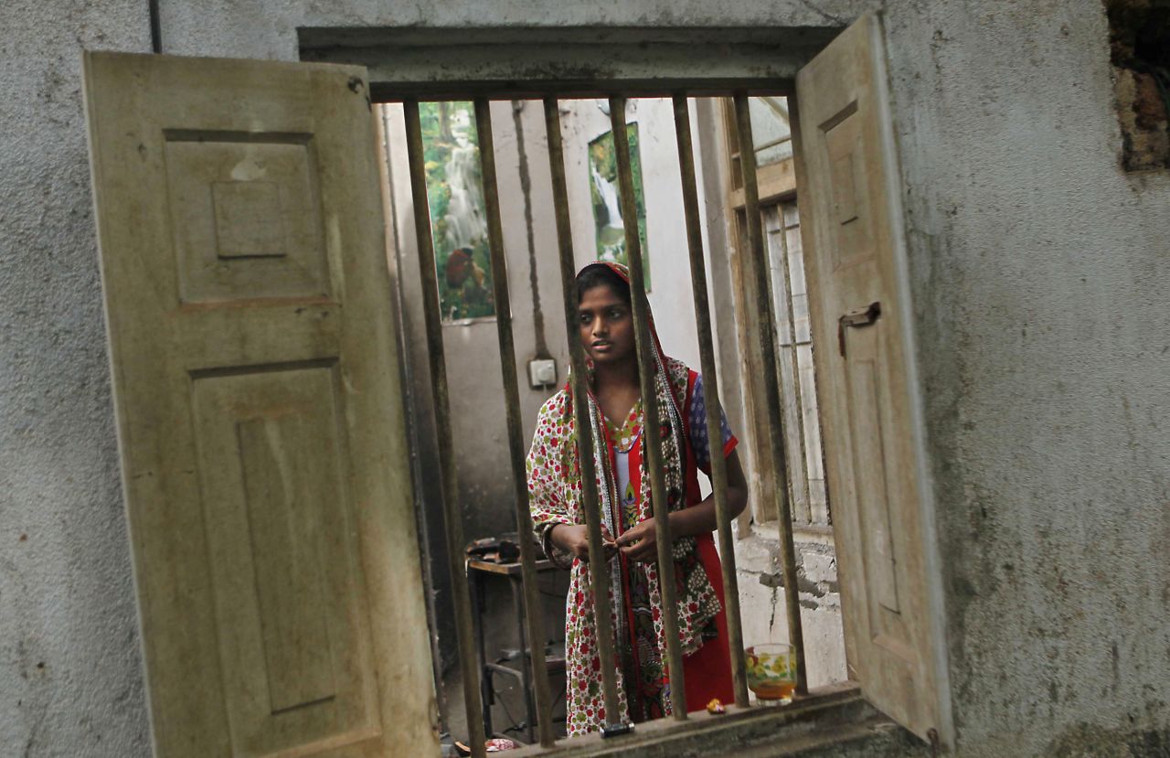 Shifna Abdul Kareem, a 16-year-old Muslim, surveys the damage to her burnt house in Adhikarigoda, a village in Aluthgama, following an outbreak of violence.