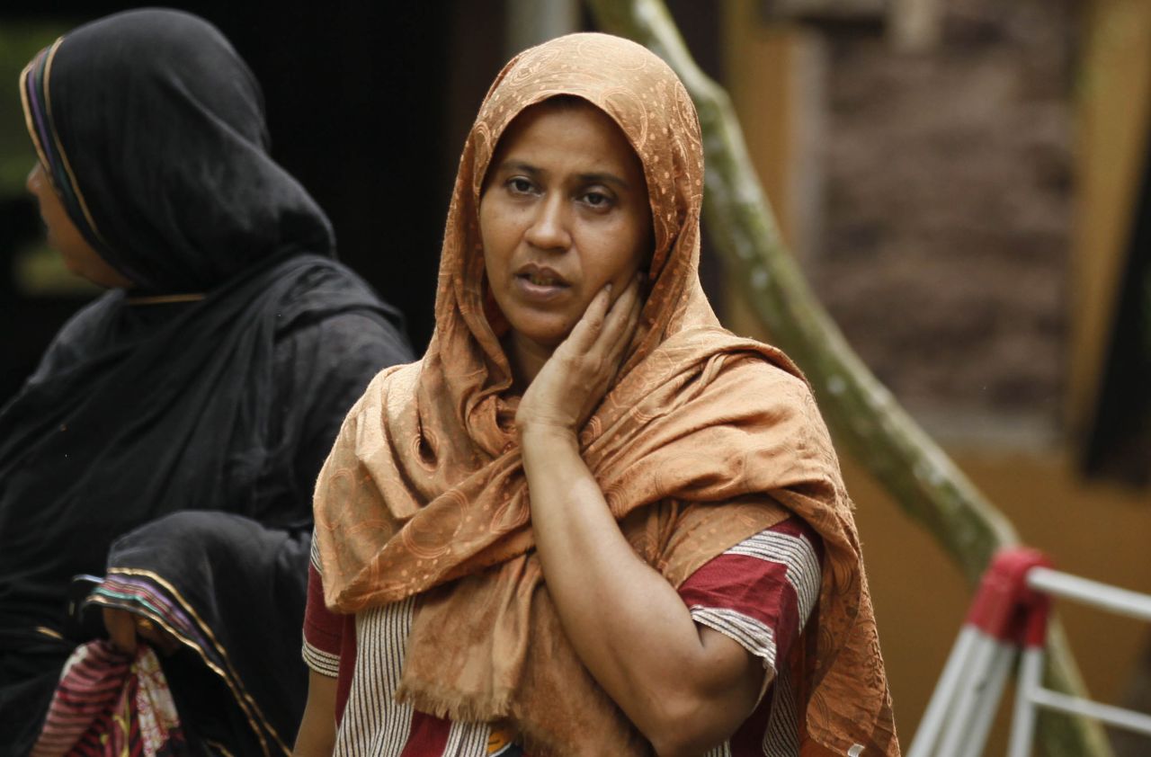 A Muslim woman observes her vandalized house in Aluthgama.