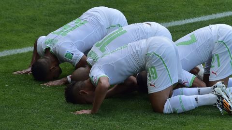 Algerian players celebrate after Sofiane Feghouli, second from left, scored on a penalty kick to give his team a 1-0 lead. 