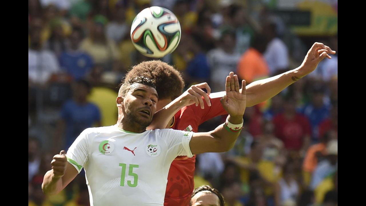 Soudani, left, goes for a header against Belgium's Axel Witsel.
