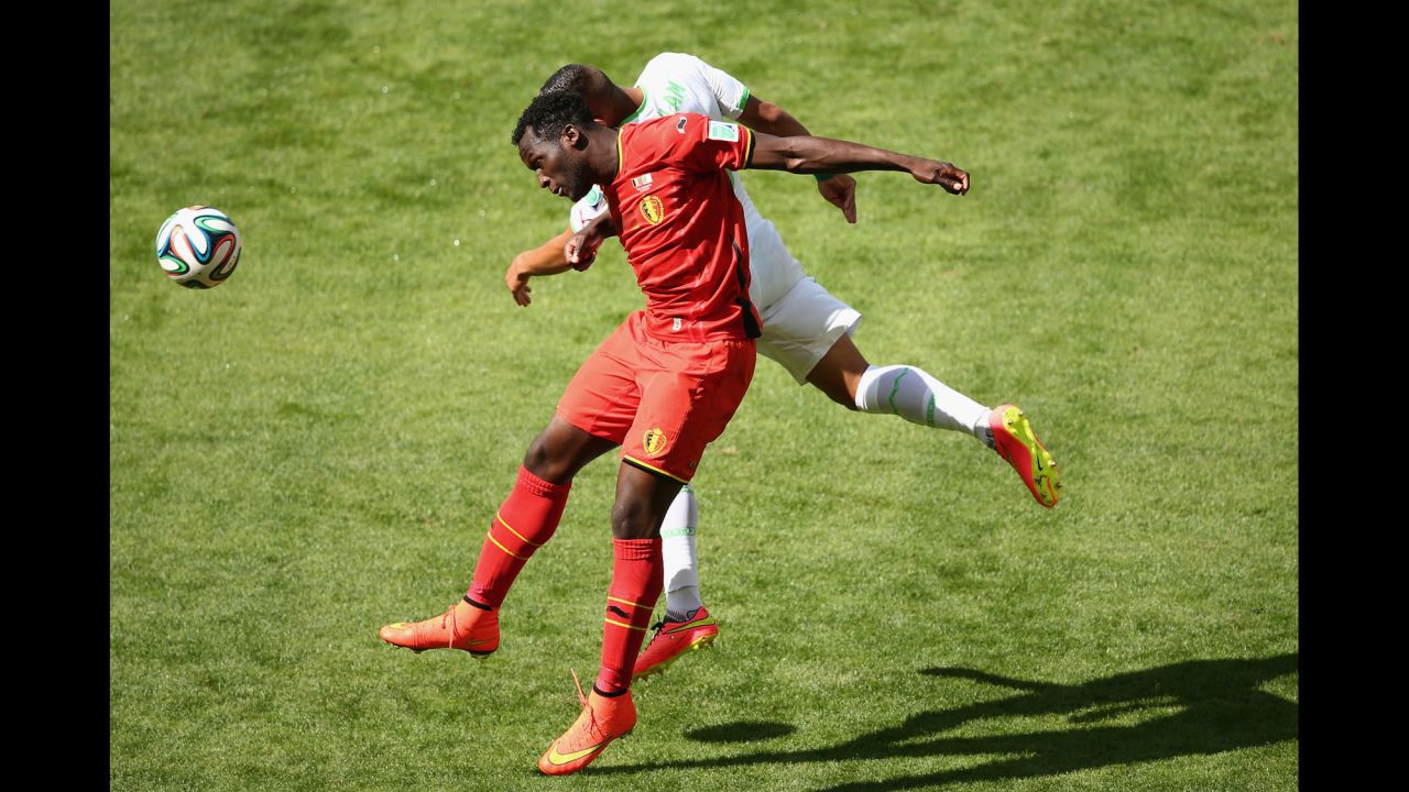 Lukaku and Faouzi Ghoulam of Algeria compete for a header.