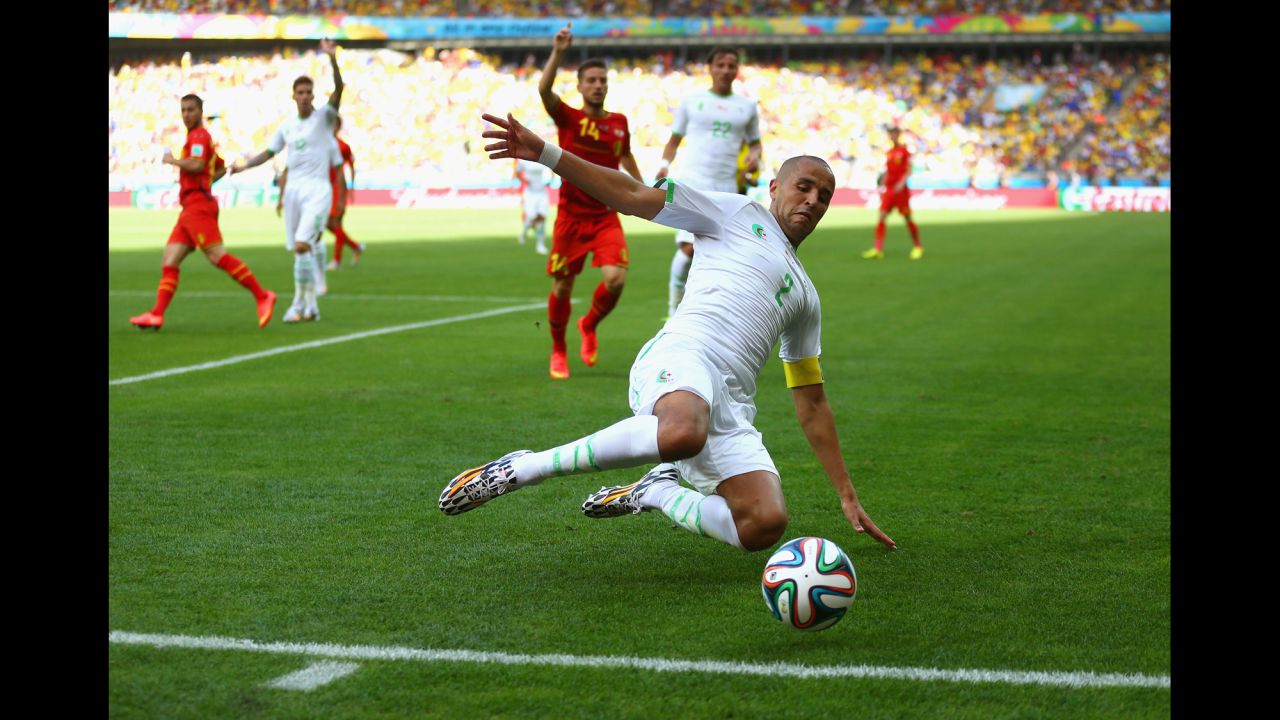 Algeria's Madjid Bougherra reaches for the ball.