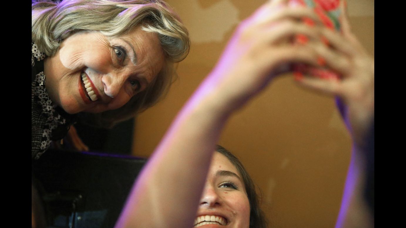 Former U.S. Secretary of State Hillary Clinton poses for a photo with a young supporter at George Washington University on Friday, June 13, in Washington. Clinton was at the school discussing her new book, "Hard Choices: A Memoir."