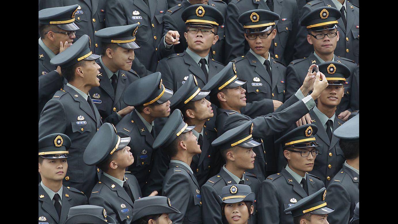 Military Academy graduates in Kaohsiung, Taiwan, take a selfie together before having a group photo taken during commencement ceremonies on Monday, June 16.