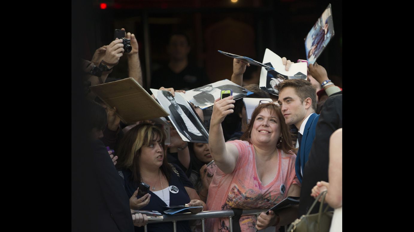 Actor Robert Pattinson poses with a fan at the premiere of "The Rover" on Thursday, June 12, in Los Angeles.