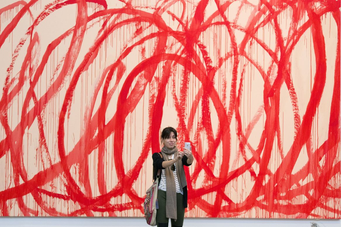 A woman snaps a selfie in front of a Cy Twombly painting Wednesday, June 11, at the Tate Modern museum in London.