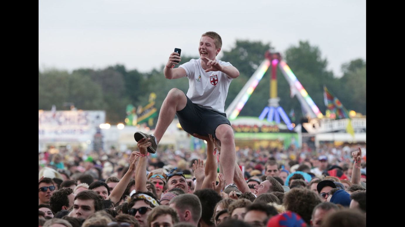 A festivalgoer takes a selfie above the crowd while The Specials play at the Isle of Wight Festival in Seaclose Park, England, on Saturday, June 14.