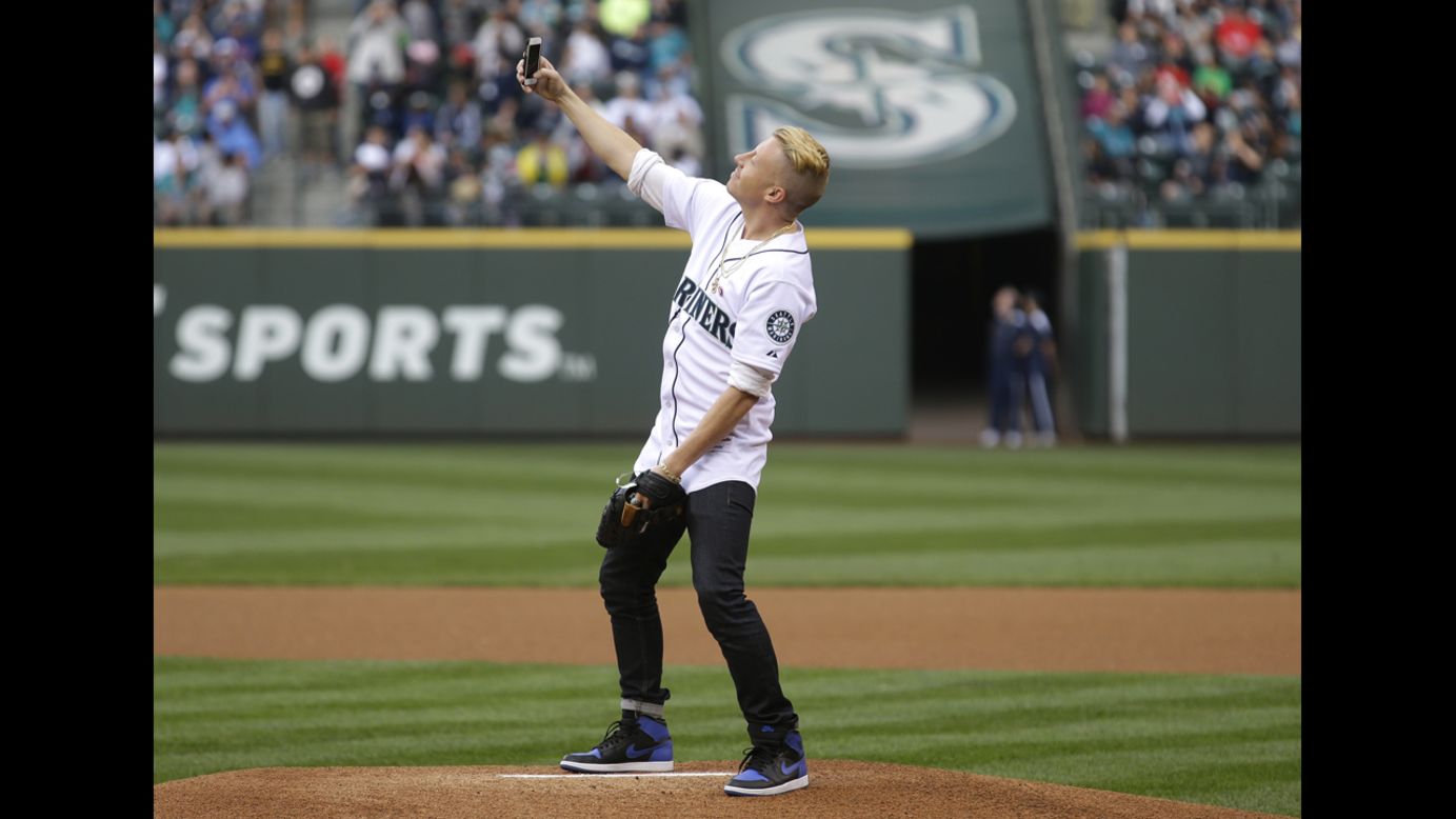 Rapper Macklemore takes a photo of himself on the mound at Seattle's Safeco Field before he threw out the first pitch before a Major League Baseball game between the Seattle Mariners and the New York Yankees on Thursday, June 12.