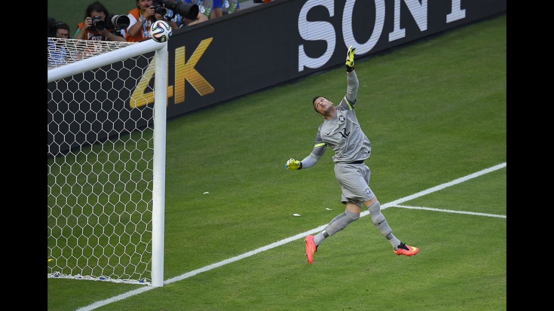 Brazilian goalkeeper Julio Cesar watches the ball fly over him.