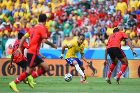 Neymar of Brazil looks to find a way through the Mexican defense.