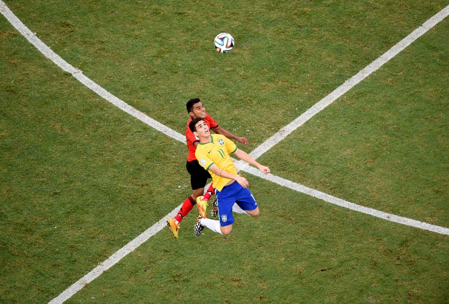 Mexican midfielder Jose Juan Vazquez, left, competes for the ball with Brazil's Oscar.