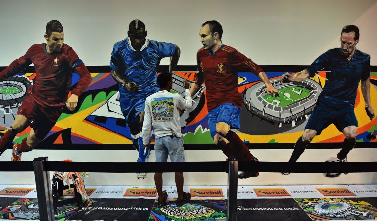 An artist works on a graffiti in celebration of the World Cup Brazil at Congonhas airport in Sao Paulo.<br /><br />No matter the frustrations felt by many Brazilians at the hosting of the tournament, the quality of the artwork it has inspired alongside it's often subversive and engaging nature is something that cannot be denied.