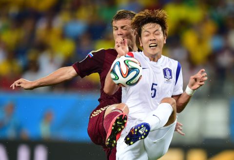 Russian forward Alexander Kokorin, left, vies with South Korean defender Kim Young-Gwon.