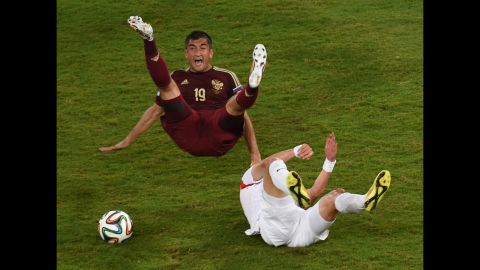 Russian forward Alexander Samedov, left, and South Korean midfielder Ki Sung-Yueng fall during the game.