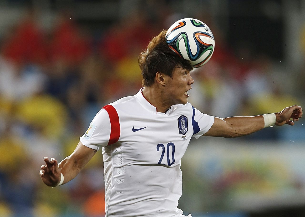 South Korean defender Hong Jeong-Ho heads the ball. 