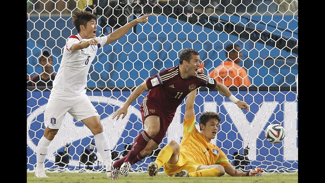 Russian forward Alexander Kerzhakov, center, reacts after scoring to tie the game.
