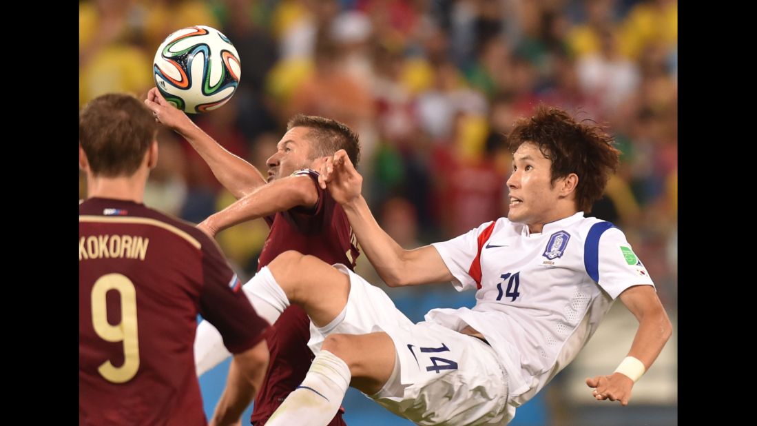 South Korean midfielder Han Kook-Young, right, vies for the ball.