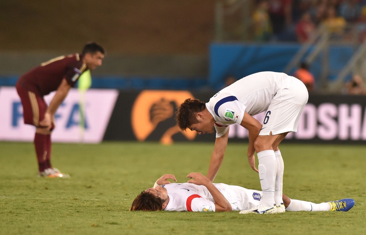 South Korean defender Hwang Seok-Ho, right, approaches a teammate at the end of the game. 