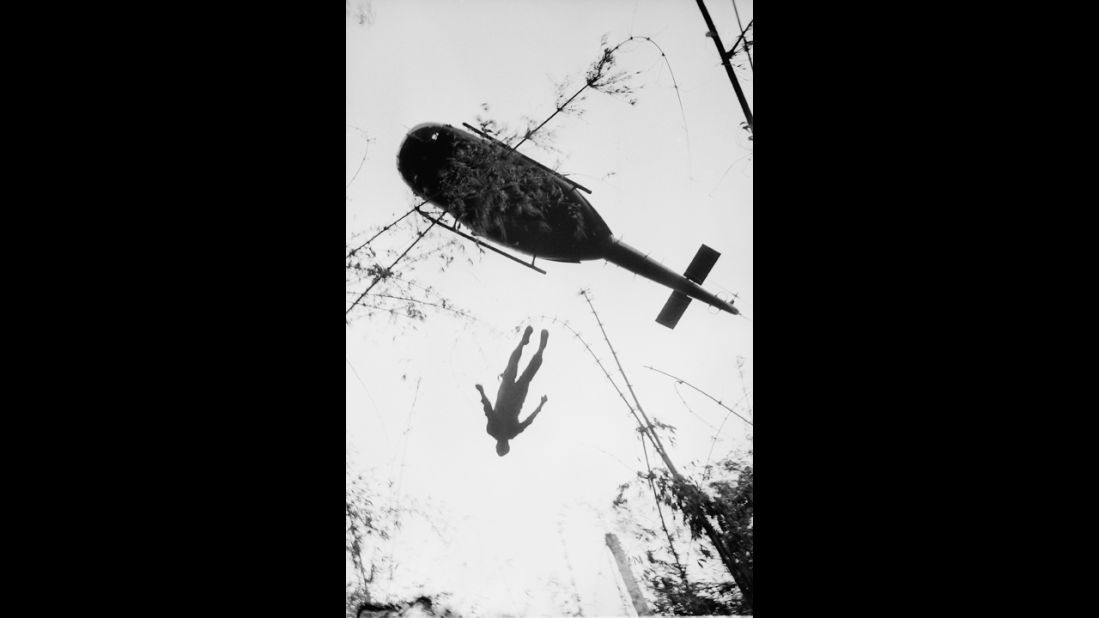 A helicopter raises the body of an American paratrooper killed in action in the jungle near the Cambodian border in 1966. Henri Huet, a French war photographer covering the war for the Associated Press, captured some of the most influential images of the war. Huet died along with LIFE photographer Larry Burrows and three other photographers when their helicopter was shot down over Laos in 1971. 