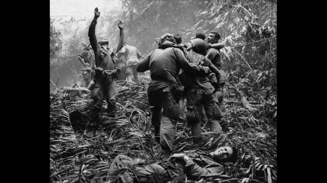 Associated Press photographer Art Greenspon captured this photo of  soldiers aiding wounded comrades. The first sergeant of A Company, 101st Airborne Division, guided a medevac helicopter through the jungle to retrieve casualties near Hue in April 1968. 