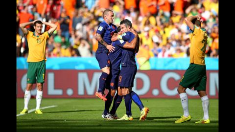 Depay, center, is hugged by teammate Robin Van Persie after he scored what proved to be the match-winning goal.