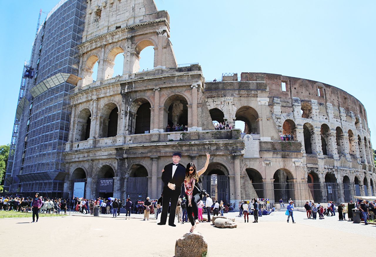 "I have a friend whose father helped me score the cutout so that it folded in and out," Yang says, here at Rome's Colosseum. "It became portable enough to carry around after I folded it up."