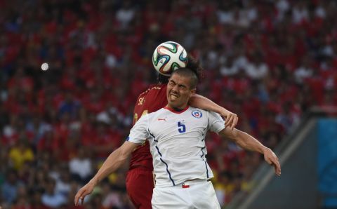 Spain midfielder David Silva, left, and Chile midfielder Francisco Silva compete for the ball.