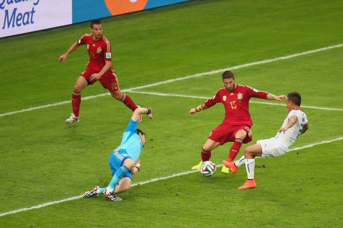 Eduardo Vargas, right, scores Chile's first goal, firing past Spanish goalkeeper Iker Casillas.