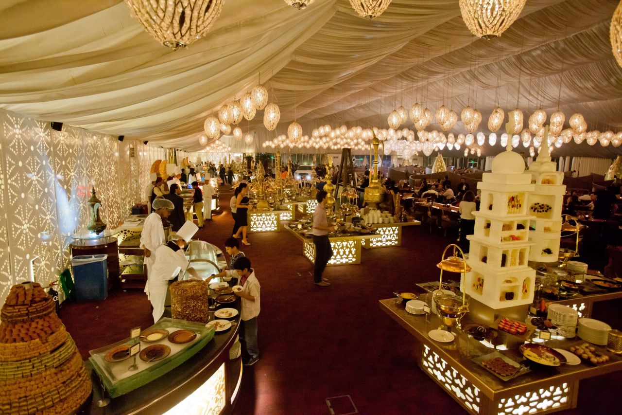 The white, billowy-walled Asateer Tent at the Atlantis Palm Jumeirah features a fountain from which sesame paste flows. 