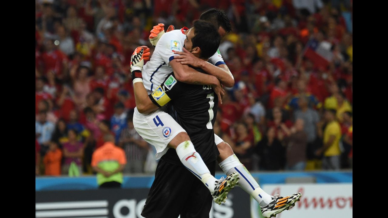 Chilean defender Mauricio Isla, left, hugs goalkeeper Claudio Bravo after the match.