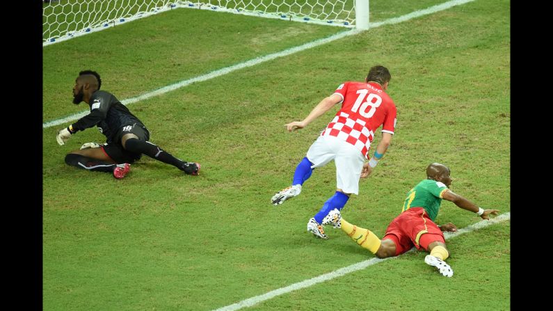 Croatian forward Ivica Olic, center, celebrates after scoring against the team's opening goal against Cameroon.